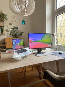 a desk with a laptop and a computer on it at Apartment_Lucas in Hamburg