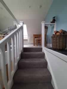 a staircase in a house with a basket at View of the Mountain in North Ballachulish