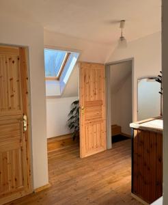an attic room with a skylight and a door at Ferienwohnung, nahe dem Faaker See in Ledenitzen