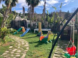 a yard with a playground with toys on the grass at Villa Casa Vacanze Fiore in Gallipoli