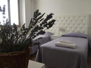 a bedroom with two beds with towels on a table at Itaka in LʼAquila
