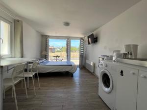 a room with a bed and a table and chairs at Tours, Touraine et Chateaux de la Loire in Fondettes