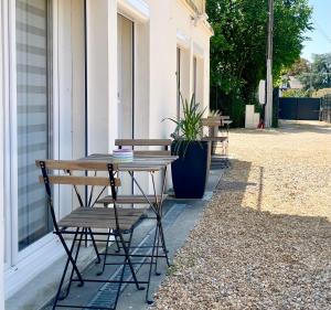 a table and chairs sitting outside of a building at Tours, Touraine et Chateaux de la Loire in Fondettes