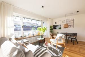 a living room with a couch and a table at WÄLDER: Quartier Birkle in Titisee in Titisee-Neustadt