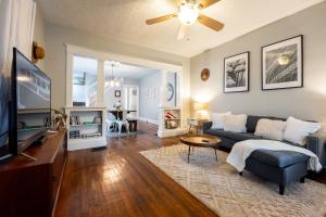 a living room with a couch and a tv at 5 Min Fountain Square - Cozy Bates-Hendricks Home in Indianapolis