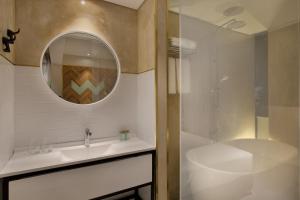 a bathroom with a sink and a mirror at Cucu Hotel By 7Minds in Tel Aviv