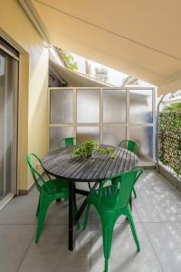 a wooden table and chairs on a patio at Luxe Athens Studio in the heart of Kolonaki in Athens