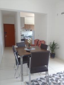 a dining room table and chairs in a living room at Praia in Praia Grande