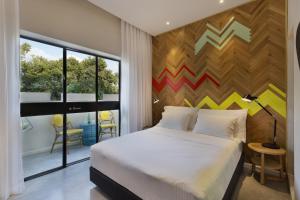 Postel nebo postele na pokoji v ubytování Cucu Hotel