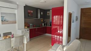 a kitchen with red cabinets and a red door at Casa Alisios - Telde in Telde