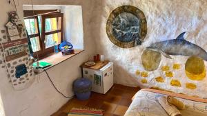 a bedroom with a painting of a fish on the wall at Studio Mazo La Habitación in Lodero