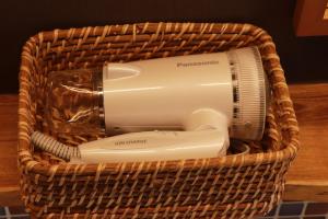 a hair dryer in a basket on a table at Cider Barn &more in Iida