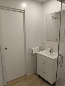 阿達萊斯的住宿－Apartamento Isabel，白色的浴室设有水槽和镜子