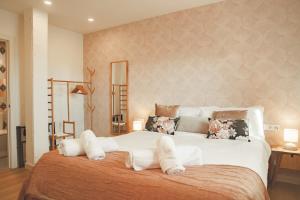 a bedroom with a large white bed with pillows at Casa Rural Passivhaus Kostoenea in Hondarribia