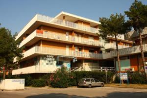 a building with a car parked in front of it at CAVALLINO in Bibione