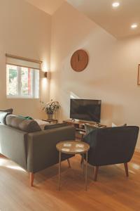 a living room with a couch and a tv at Casa Rural Passivhaus Kostoenea in Hondarribia