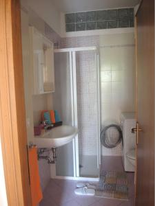 a bathroom with a sink and a toilet at CAVALLINO in Bibione +19 photos