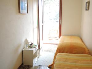 a bedroom with a bed next to a window at CAVALLINO in Bibione