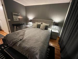 1 dormitorio con 1 cama grande y 2 mesitas de noche en Mysig gästhus i Uppsala/Norra Årsta en Uppsala