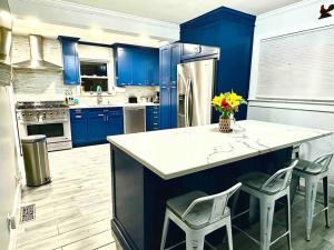 a kitchen with blue cabinets and a white counter top at Entire home- pool, gym, theater. 10 min from NYC. in Yonkers