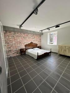 a bedroom with a bed and a brick wall at Apartament in Străşeni