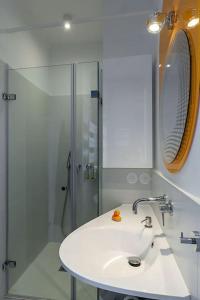 a bathroom with a white sink and a shower at 2P Bonjour Soleil (Sea View/Terrasse&AC) in Nice