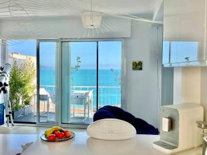 a kitchen with a table with a bowl of fruit on the counter at 2P Bonjour Soleil (Sea View/Terrasse&AC) in Nice