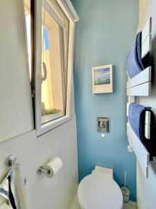 een blauwe badkamer met een toilet en een raam bij 2P Bonjour Soleil (Sea View/Terrasse&AC) in Nice