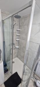 a shower with a glass door in a bathroom at Studio plein Sud au calme in Montauban