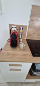 a red backpack sitting on top of a desk at Studio plein Sud au calme in Montauban