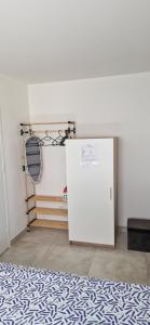 a room with a white refrigerator in a room at Studio plein Sud au calme in Montauban