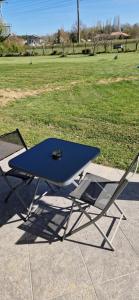 a blue ping pong table and a chair in a field at Studio plein Sud au calme in Montauban