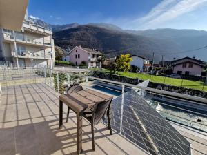 a balcony with a table and a view of a mountain at VILLA CLAUDIA WITH PRIVATE POOL in Colico