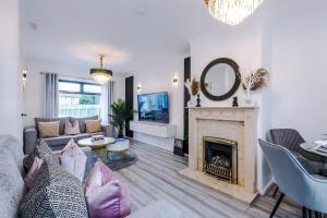 a living room with a couch and a fireplace at New 2 Bed House - Perfect for Contractors & Families By AV Stays Short Lets St Helens in Saint Helens