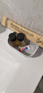 a toothbrush and two jars of honey on a counter at Studio plein Sud au calme in Montauban