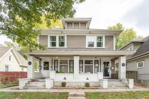 a house with a white front porch at Cozy Home Near Fountain Square & 5 Min Lucas Oil in Indianapolis