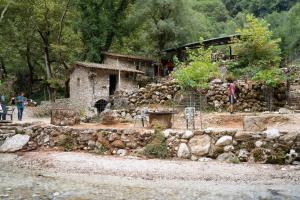 a group of people standing in front of a stone building at Artemis Villas in Gardíkion