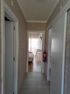 a hallway leading to a living room with a fire hydrant at apartamento perto do Santuário in Fátima