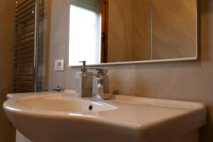 a white sink in a bathroom with a mirror at Casa Martina Tuscany in Certaldo +26 photos