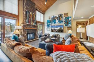 a living room with a large couch and a fireplace at Trot Ski-House in Breckenridge