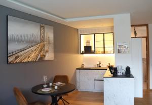 a living room with a table and a kitchen at Ausblick Kleinjuwel mit Panoramablick + Garage in Merano +50 photos