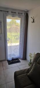 a living room with a door open to a patio at Studio plein Sud au calme in Montauban