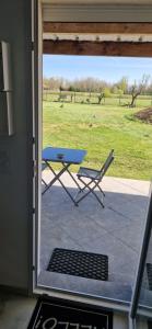 a patio with a table and a chair outside a door at Studio plein Sud au calme in Montauban