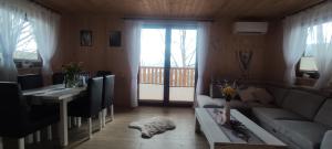a living room with a couch and a table at Relaksówka in Roztoka
