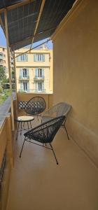 尼斯Le Virenque的阳台设有两张长椅和一张桌子