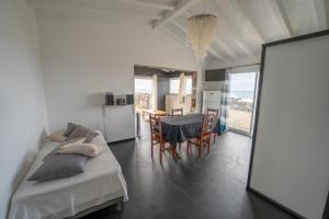 a room with two beds and a table and a kitchen at Casa Atlantida - Sea front in Faja Grande