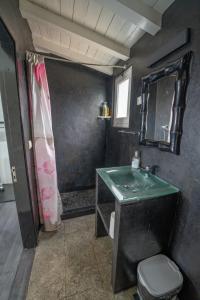 a bathroom with a green sink and a toilet at Casa Atlantida - Sea front in Faja Grande