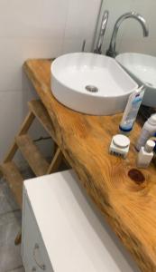 a bathroom with a sink on a wooden counter at Casa Herzliya in Herzliya