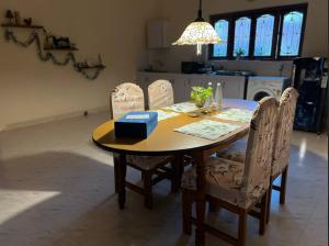 a dining room table with chairs and a blue box on it at Casa Amarela in Cuncolim
