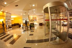 a lobby of a building with a large glass doorway at Ritz Plaza Hotel in Juiz de Fora